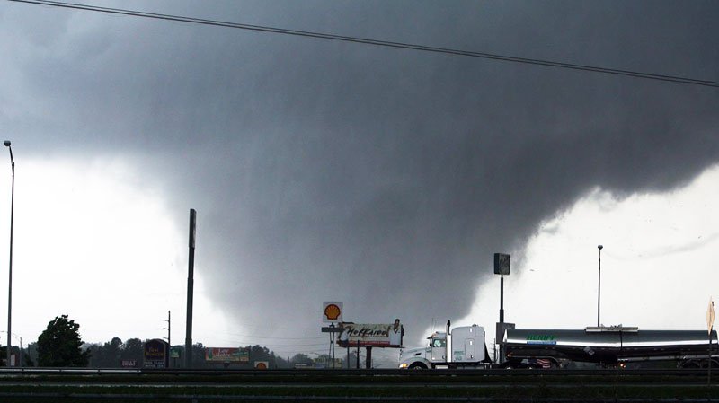 people running away from tornado. A tornado moves t.