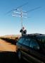 Raising antennas in DM83. I had hoped to operate from the mesa in the background, but could not find open access to the top. Note the wind generators on the top of the mesa.