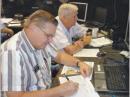The Tuscaloosa County (Alabama) ARES participated in the 2010 Simulated Emergency Test. Dennis South, KD4IDD (left), and Bob Hudson, KF4UCY, conduct a VHF net during the SET. [Eddie Lary, WS4I, Photo]