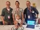 HamX keynote speaker Thomas Witherspoon, K4SWL; Boston ARC members and POTA enthusiasts Brendan Baldonado, NW1S; Tom Ulrich, KC1OCY; and Brendan’s child, Seamus.