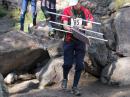 After leaving the 2 meter starting point, competitors had to be nimble to get down into the canyon that served as a corridor into the forest. First in this group of starters is Matthias Kuehlewein, DL3SDO, followed by Alla Mezhevaya and Vadim Afonkin, KB1RLI. Mezhevaya and Afonkin are wearing the Team USA orienteering outfits that they wore at the 2010 ARDF World Championships in Croatia. Their RDF Yagis have flexible steel tape elements. [Joe Moell, K0OV, Photo]