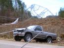 North of Fordyce, a steel transmission tower was mangled along Arkansas Highway 273. A pickup truck ran into fallen lines. [Photo courtesy of Little Rock NWS office]
