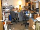 A trashed hamshack, all of the desk space covered in radios, books, food, repeater equipment and foxhunt stuff.