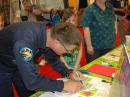 Astronaut Wheelock signs an autograph in the ARRL Expo Youth Lounge.