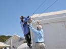 Two men erect the much-needed antennas to be used by Amateur Radio operators to provide communications support. 