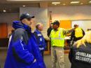 After an EF4 tornado swept through the town of Henryville, Indiana on March 2, Clark County Emergency Management Director Les Kavanaugh (in yellow vest) gives instructions to Richard Bowyer, W9TDI, prior to Bowyer heading into the field. [Photo courtesy of Jeffrey Brady, N9WSV]