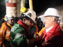 Chilean president Sebastian Piñera (right) hugs Luis Urzua, the last miner out of the rescue hole at the San Jose mine near Copiapo, Chile on October 13, 2010. [Photo courtesy of Hugo Infante/Government of Chile]