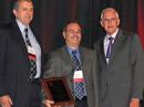 WX4NHC Assistant Coordinator Julio Ripoll, WD4R (center), receives the Distinguished Service Award at the National Hurricane Conference earlier this month. He is flanked by NHC Director Bill Read, KB5FYA (left), and former NHC Director Max Mayfield. [Photo courtesy of John McHugh, K4AG]