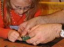 Amelia Merithew, assisted by her father Robert, KD8BDA, assemble one of the project kits in the ARRL EXPO area at the 2009 Dayton Hamvention. [S. Khrystyne Keane, K1SFA, Photo]