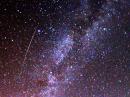 A Perseid meteor passes near the Milky Way in 2009.