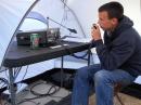 KF7MQU operating HF inside a tent with one of his first ham radios. [Colton Cox, KF7MQU, Photo]