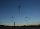 The discone at dusk. The antenna wire and support structure are clearly visible.