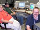 The Radio Room of the Harrison County Emergency Operations Center during Gustav. From left, Judy Craven, KC5NXH; Anthony Allen, KE5VAG, and David Craven, AC5CU, monitor the radios and other communications equipment during Hurricane Gustav. [Tom Hammack, W4WLF, Photo]