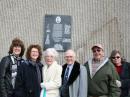 Corwin family members pose in front of the black granite plaque marking the site of the Corwin residence.