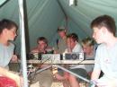 A group of Scouts crowd around the radios during a summer camp session for the Boy Scout Radio merit badge.