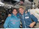 Expedition 17/18 Flight Engineer Greg Chamitoff, KD5PKZ (left), and Richard Garriott, W5KWQ, pose for a photo in the Zvezda Service Module of the International Space Station. [Photo courtesy of NASA]