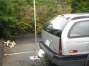 Base of the trailer hitch mounted 20ft HF vertical showing ground radials and AH4 automatic antenna tuner.