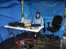 Melisa KE7KRS inside the shelter during the first squall, but before the canopy got blown over and radios got soaked (notice she's still smiling).