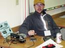 Phil K7PIA- a ham intent on learning Morse code, practices sending.  The red and black key is the raffle prize for entrants to try out.