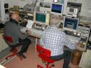 Mario I1ANP and Giorgio IK1UWL facing 2 receivers and 3 computers
