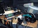 The passenger's seat is taken over by radios and a big wire mess.