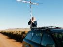 Raising antennas in DM83. I had hoped to operate from the mesa in the background, but could not find open access to the top. Note the wind generators on the top of the mesa.