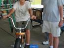 Dustin Shelton, Troop 98, peddling the bicycle generator made by Dan McCabe, WA8YYE.  Dustin recently completed his Radio Merit Badge