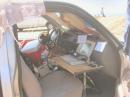 "In the Cockpit," this is the interior of the cab when N8LXR Mobile is rigged up for competitive mobile contesting.
A small operating surface supporting the control head of the FT-100D, an old Toshiba 486 laptop with NA contesting software featuring automated CW exchanges, a pair of Bencher paddles, and some lights to illuminate the operating position is shown mounted on the passenger side.
In the middle of the front seat is a small console with various controls for tuning the antenna, turning lights on and off, etc, a few junction boxes with jacks for keying, headphones, and microphone - all set ip so the operator can control things from inside the cab without having to get out.