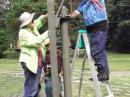 Diane-W7SIM and Armand-KA5BBG assemble one of the clubs two military surplus crank up towers. This one was used for the 20M PH Yagi. This station made 692 QSOs.