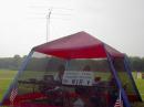Jim Bowman,KS1J, operates CW while Joe Natale,K1JN, operates phone from the primary HF tent. The HF tower is in in the background.
