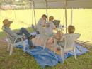 Jim Kernan (KC0WHI), Steve Heyroth (K5MNZ), Stacey Weir, and Sherry Weir (KB0SQQ) enjoy the early afternoon shade at the 40m station.