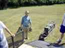 John, W3GJN, helping with unloading of towers.  Each tower consists of a group of tubes in the "Rocket Launcher" which also serves as the base section, as well as a bag containing guys, ground anchors, antenna mounting fixture, and clamps for the tower sections.