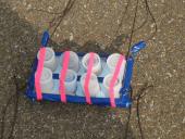 Olde Towne Middle School picture of Film Canisters taped together in pairs with pink tape