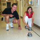 Two teachers set their BOE-BOT programmable robot vehicles loose on the hallway obstacle course during the 2004 Teachers Institute.