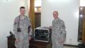 Army Major Scott Hedberg, AD7MI (left), of Leavenworth, Kansas, hands over the BARS station duties to Army Captain Jeffrey Hammer, N9NIC, of Speedway, Indiana, in April 2008. [Photo courtesy of Army MARS]