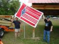 Mayor Larry Justice and club member Mike Wegner, KI4TWB raise the ARRL flag.