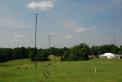 The "Lines".  Our 13 towers with yagis on top and wire antennas between are setup in two lines along a fairly unobstructed 1000 foot line with all antenna patterns "end to end".  Our operating tents are visible on the right. 