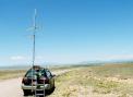 In DM74 southeast of Moriarty. The Sandias are to the left and the Ortiz mountains to the right in the background. Albuquerque is behind the Sandias.  The loop is at the top of the stack, then the 11 element 432 MHz WA5VJB Yagi, and then the 3 element 2M liaison antenna. The antennas are configured in the raised and stopped position.