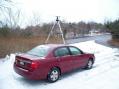 In this photo that was taken on Sunday, you can see the three-element Two Meter Yagi that is mounted on a tripod on top of the car roof and the three-element Six Meter Yagi that is inserted into an umbrella stand that is located in front of the car.  Note the large snow flakes that was coming down at the time!