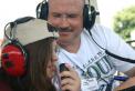 Kevan, KE5TYS, watches daughter, Alyssa, make her first ham radio contact on the GOTA station.