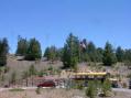 Field Day site, Our comm bus and 3 towers on hill, 2 CW 1 SSB and the VHF mast/ flagpole on the bus