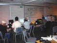 Everyones' back as they operate. Tom and Bernie on 40m, and Jeff on 20. Tom's dad is observing. The EOC was a little dark, but better than having the fluorescent light hum on top of all of the electrical noise. 