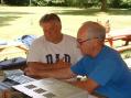 Commissioner Oscar Cowen (on left) gets a lesson on how to work a CW contact from Don Smith WA9KRT.