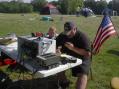Mike Octeau, the EMA director for Hopkinton, RI,  sits in and operates the GOTA station as his son Ben patiently awaits his turn at the controls. Mike said he would like to get his ham license now that he experienced Amateur Radio's capabilities first hand.