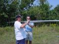 N3JDR and W8CMK attach the two meter antennas to the mast.