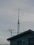 A slightly lumpy, single-turn, shielded loop of 1/2" CATV hardline sits atop a lesser tower at N0AX.  This is a dual-band loop and can be used on 80-meters, as well.  A reed-relay in a switchbox at the base of the loop selects the appropriate tuning trimmer capacitor to resonate the loop. DC for the relay is sent through the feedline.