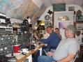 GARY W0ZXO by the door 15mtr position; BOB  W5XW facing the
camera at 20mtr position; Chuck KD5PEG taking a break and
using his cell phone. Inside KC5OEG BackYard Ham-Shack.