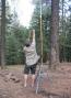 Dave uses a slingshot to fire a fishing line high into the pines, then hoists another 100 feet of feed line.