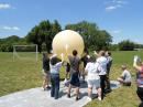 Teachers at the workshop outfitted a high-altitude balloon with a sensor package. The balloon remained tethered during the demonstration.