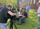 Teachers decode the SSTV image over a picnic of pizza and wings while a photojournalist from WFSB-TV shot video of them. [Sierra Harrop, W5DX, photo]
